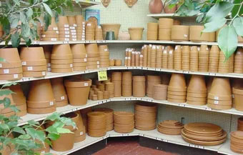 shelves with various sizes of terracotta pots at Coulter Gardens in Amarillo, TX